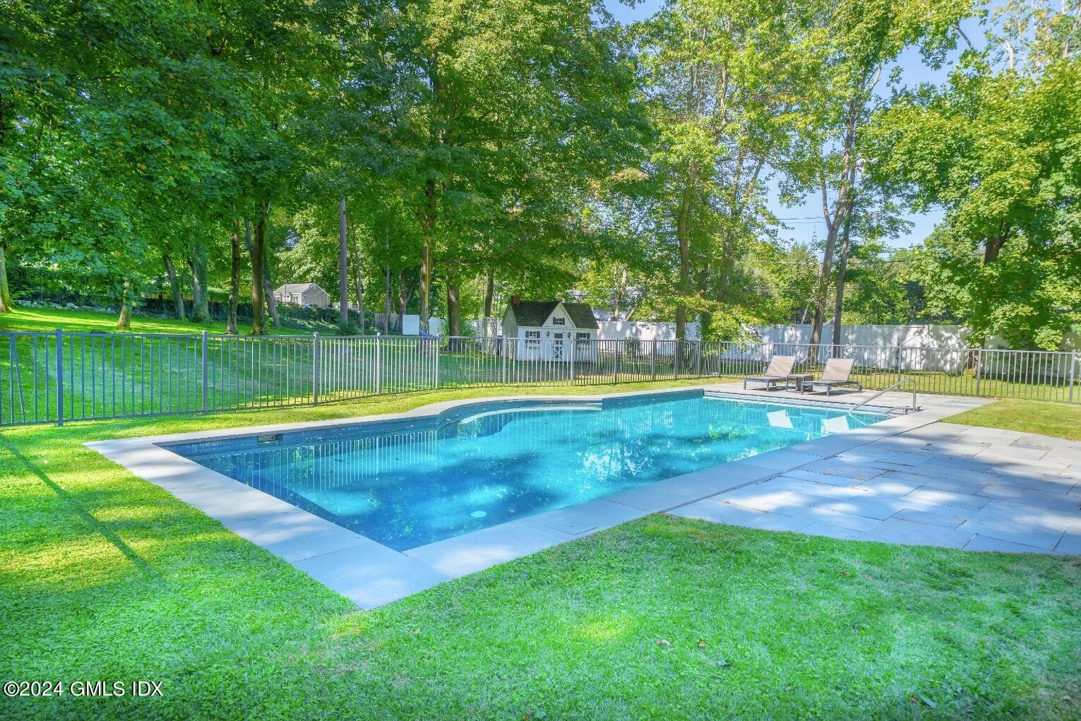 62 Brookridge Drive Greenwich, CT 06830 - Photo 12 of 13 a view of a swimming pool with a big yard