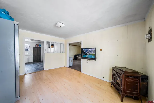a view of a bedroom with furniture and wooden floor