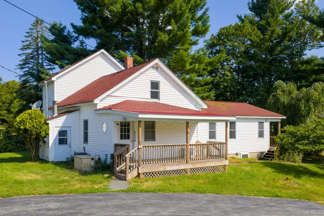 a front view of a house with a yard and porch
