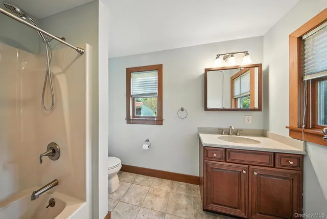 a bathroom with a double vanity sink mirror and shower