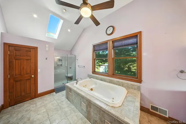 a bathroom with a tub and a large window