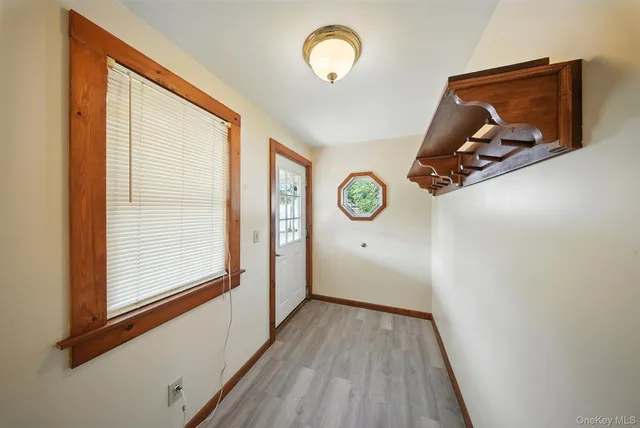 a view of a room with wooden floor and window