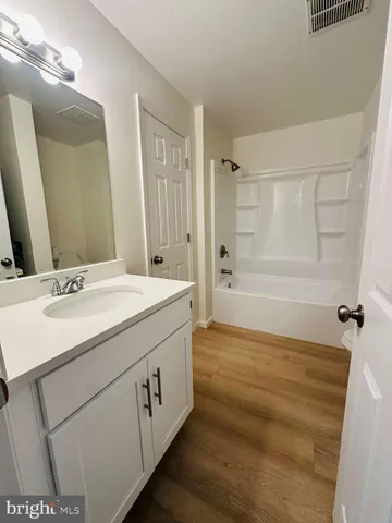 a bathroom with a sink a mirror and a bathtub