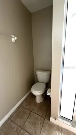 a white toilet sitting next to a white sink