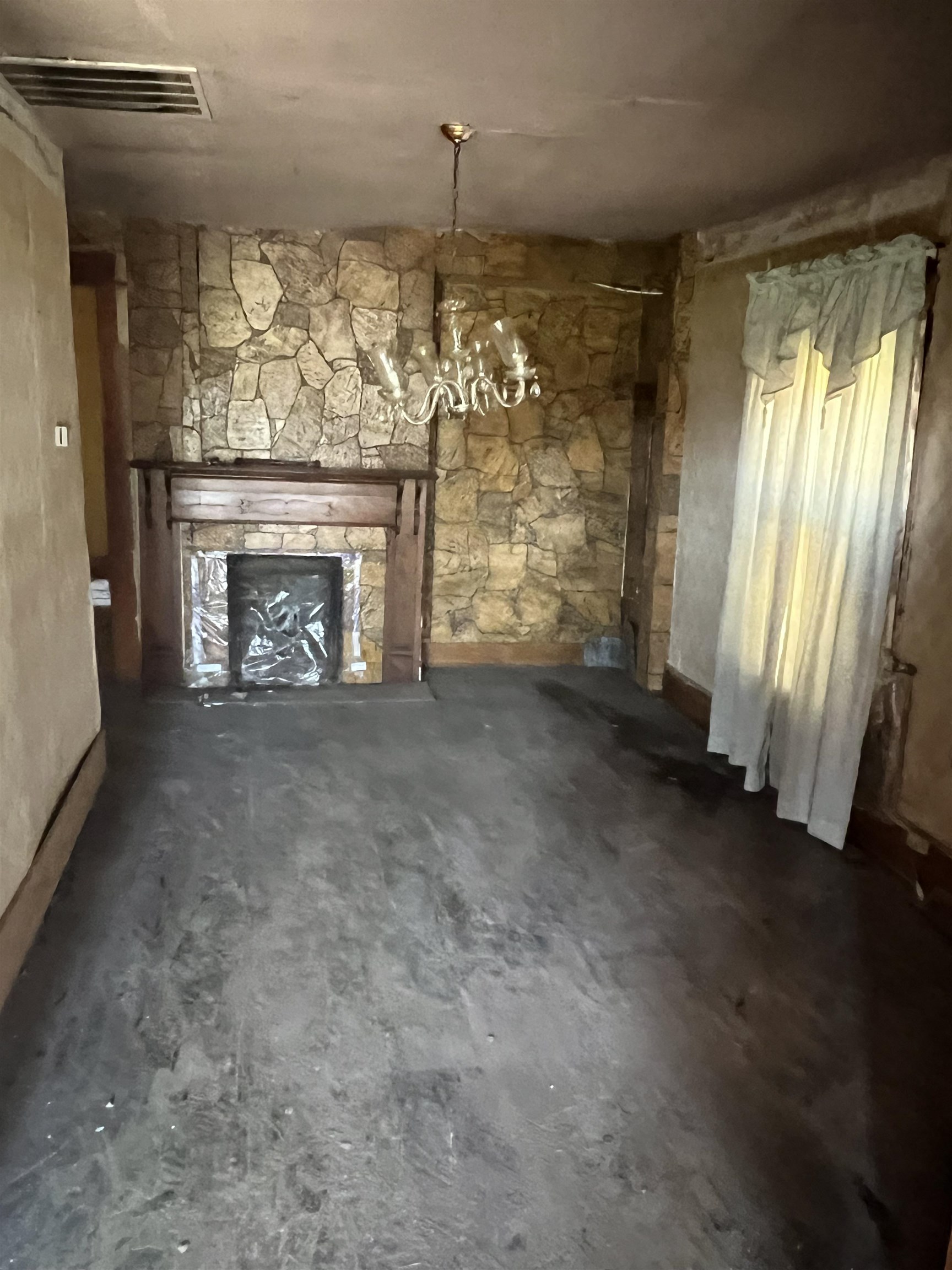 1211 Sylvan Street Memphis, TN 38107 - Photo 8 of 19 an empty room with windows fire place and an entrance