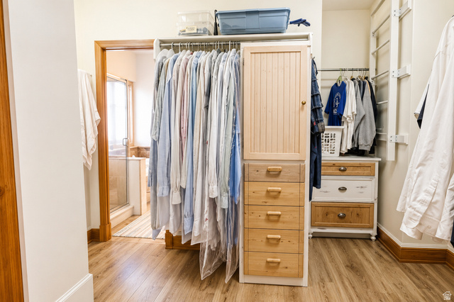 1055 North 1000 East Mapleton, UT 84664 - Photo 10 of 112 Walk-in closet featuring wood-finish flooring, built-in cabinetry with drawer storage, and extensive hanging rods