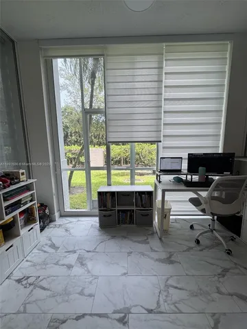 a reading room with furniture and large windows