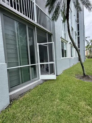 a view of backyard with potted plants and wooden fence