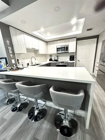 a kitchen with a table and chairs