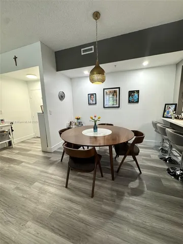 a view of a dining room with furniture and wooden floor