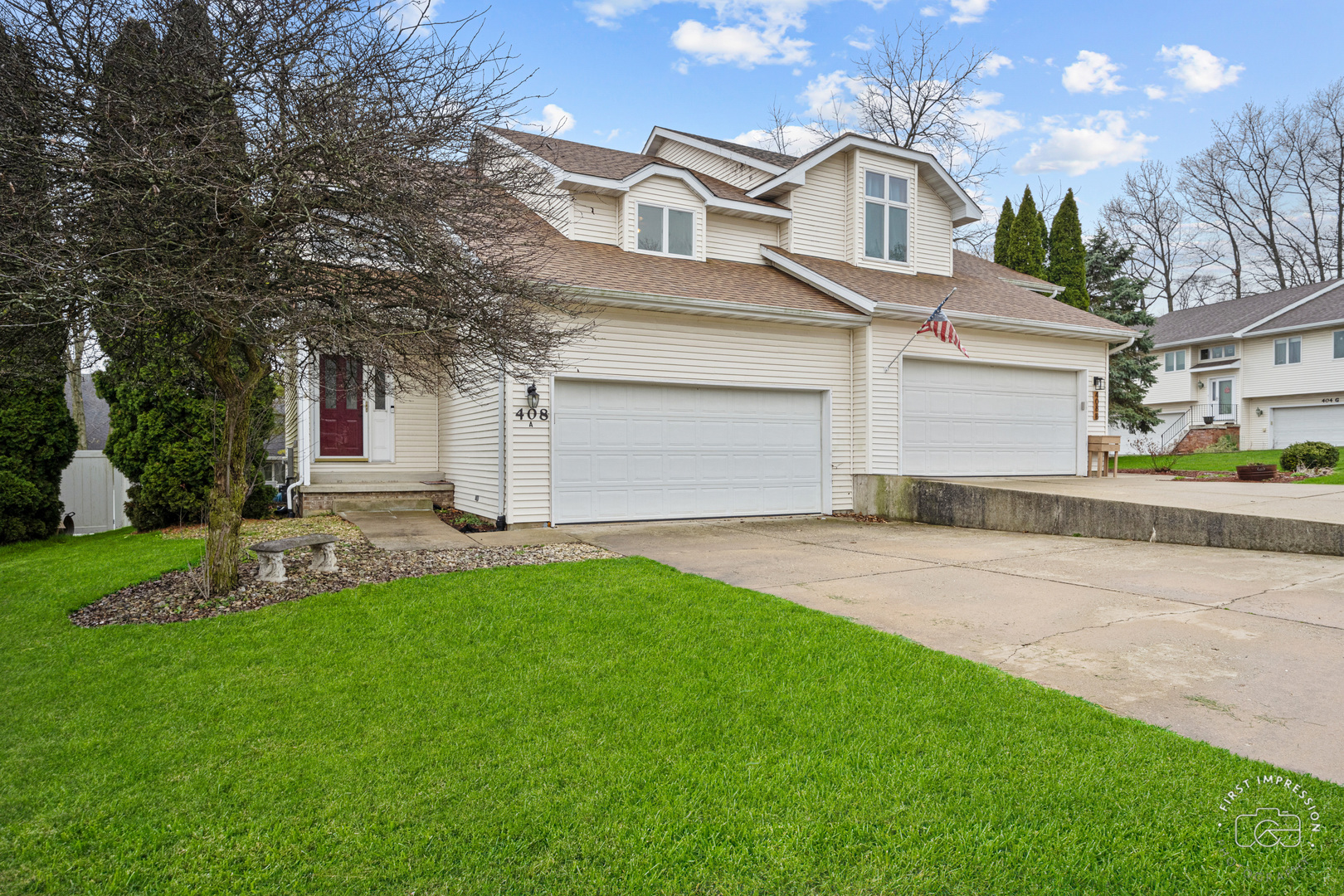 408 Grande Drive, Unit A Minooka, IL 60447 - Photo 1 of 20 a front view of a house with a garden and yard
