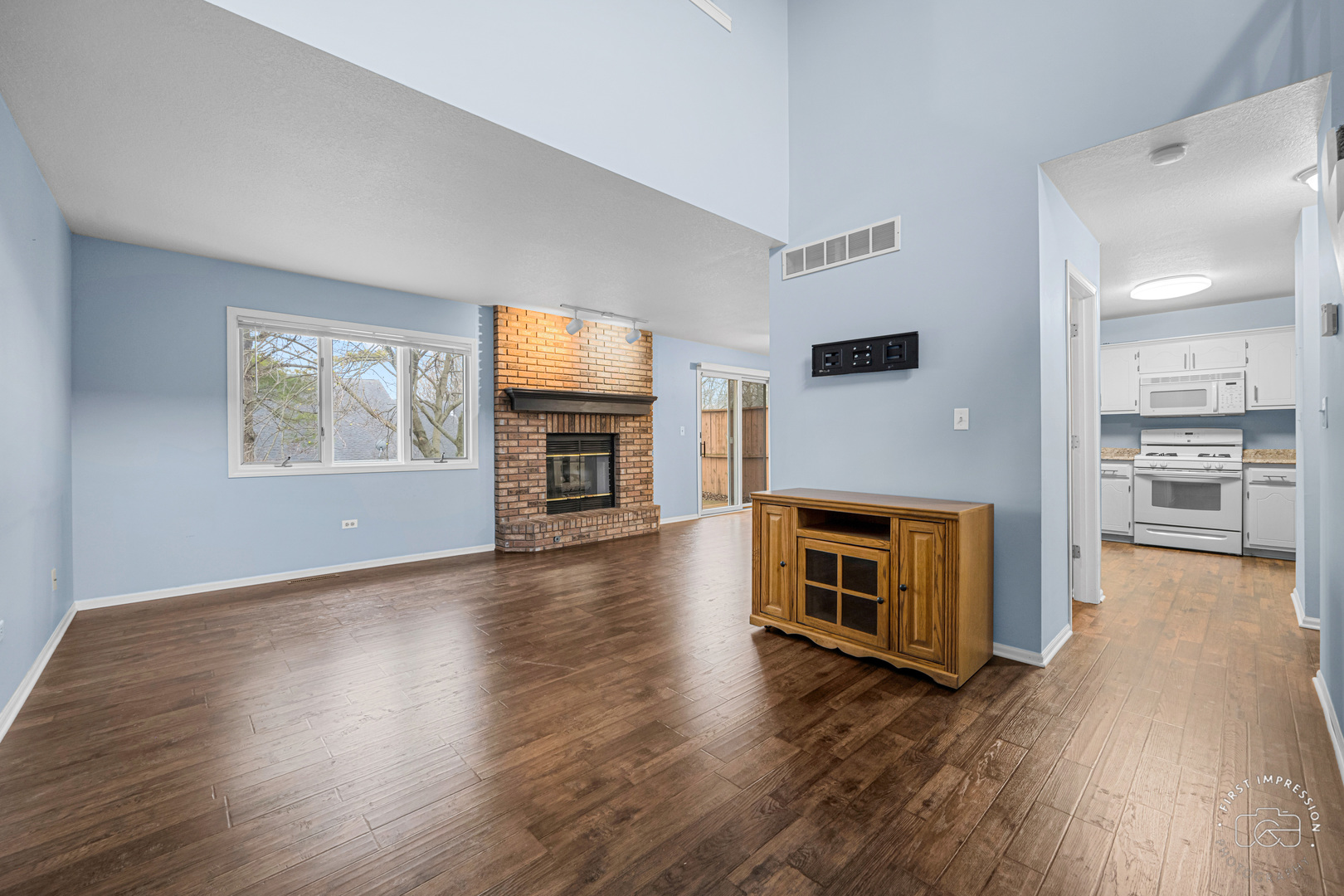 408 Grande Drive, Unit A Minooka, IL 60447 - Photo 4 of 20 a living room with stainless steel appliances furniture a fireplace and wooden floor