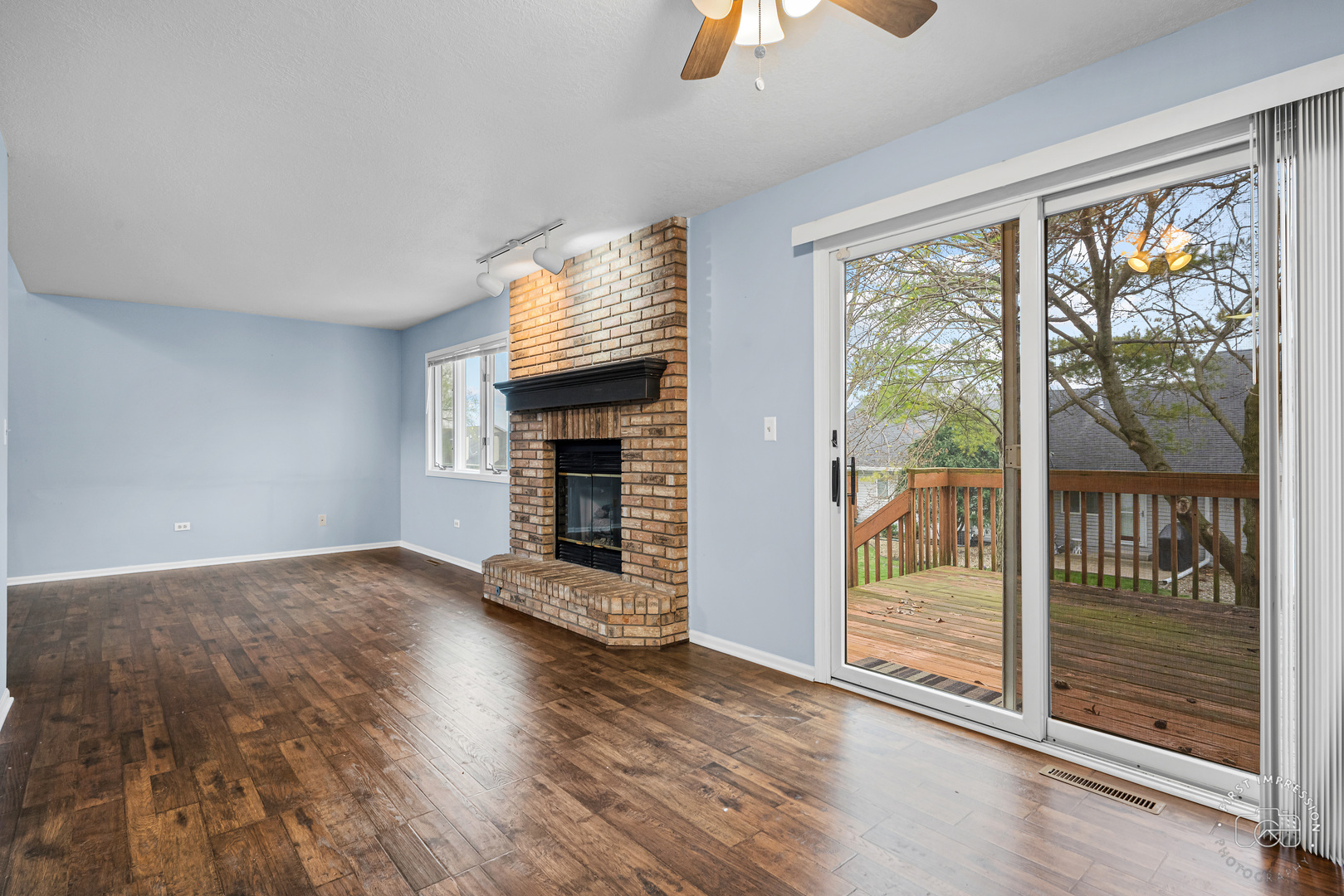 408 Grande Drive, Unit A Minooka, IL 60447 - Photo 6 of 20 an empty room with wooden floor fireplace and windows