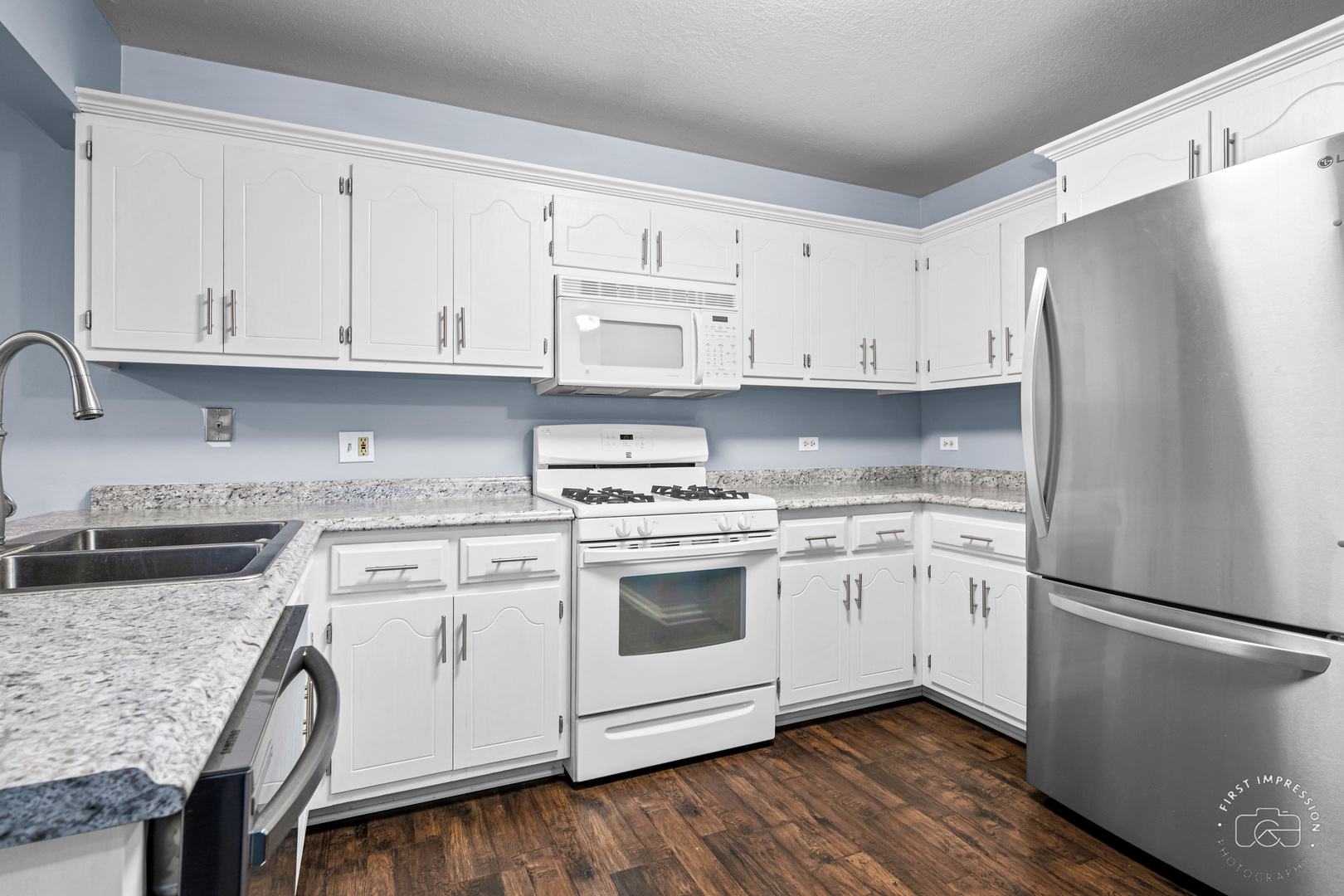 408 Grande Drive, Unit A Minooka, IL 60447 - Photo 8 of 20 a kitchen with stainless steel appliances granite countertop a refrigerator sink and white cabinets