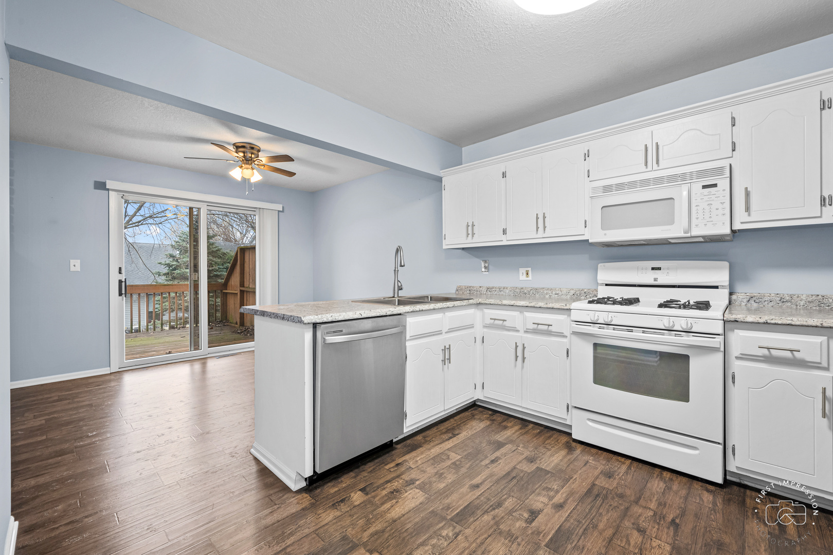 408 Grande Drive, Unit A Minooka, IL 60447 - Photo 9 of 20 a kitchen with granite countertop white cabinets and white appliances