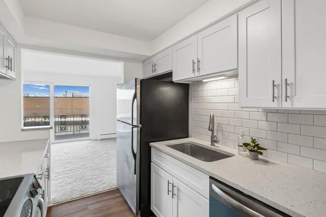 a kitchen with a sink and refrigerator