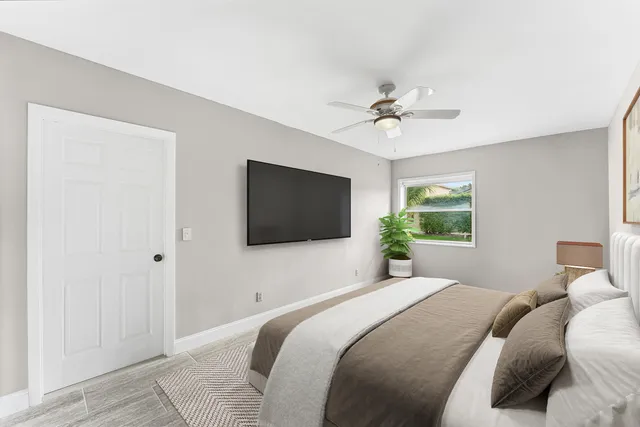 a bedroom with a bed and a flat screen tv