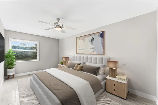 a bedroom with a bed and a painting on the wall