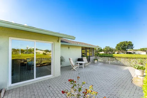 a view of a patio with a table and chairs