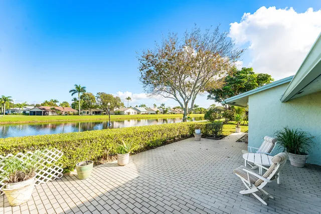 a view of a lake with table and chairs