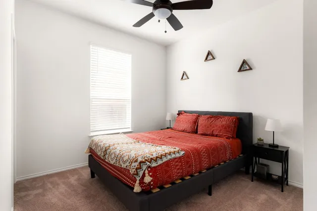 a bedroom with a bed and window