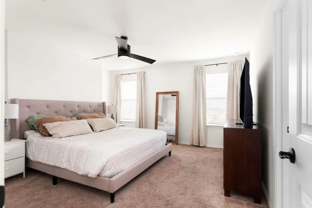 a bedroom with a bed and a window