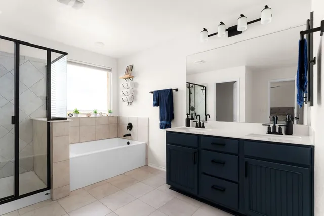 a bathroom with a tub sink and mirror
