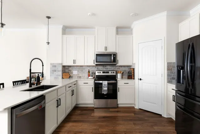 a kitchen with a refrigerator and a sink