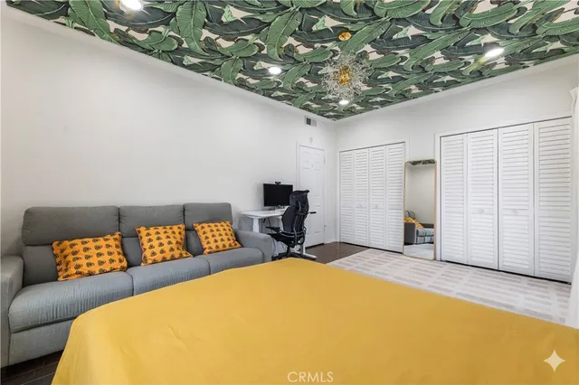 a bedroom with a bed and a couch