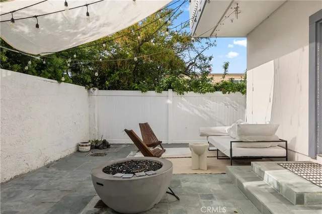 a view of a patio with table and chairs and potted plants