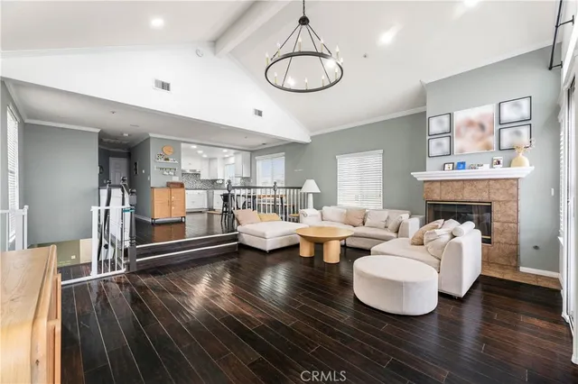 a living room with fireplace furniture and a wooden floor