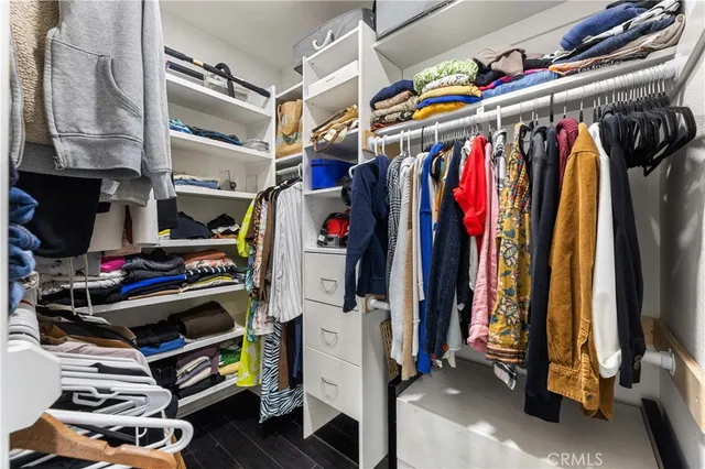 a view of walk in closet with clothes