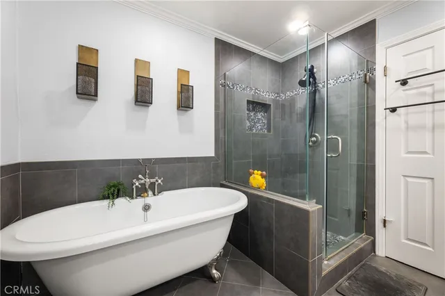 a white bath tub sitting next to a bathroom sink