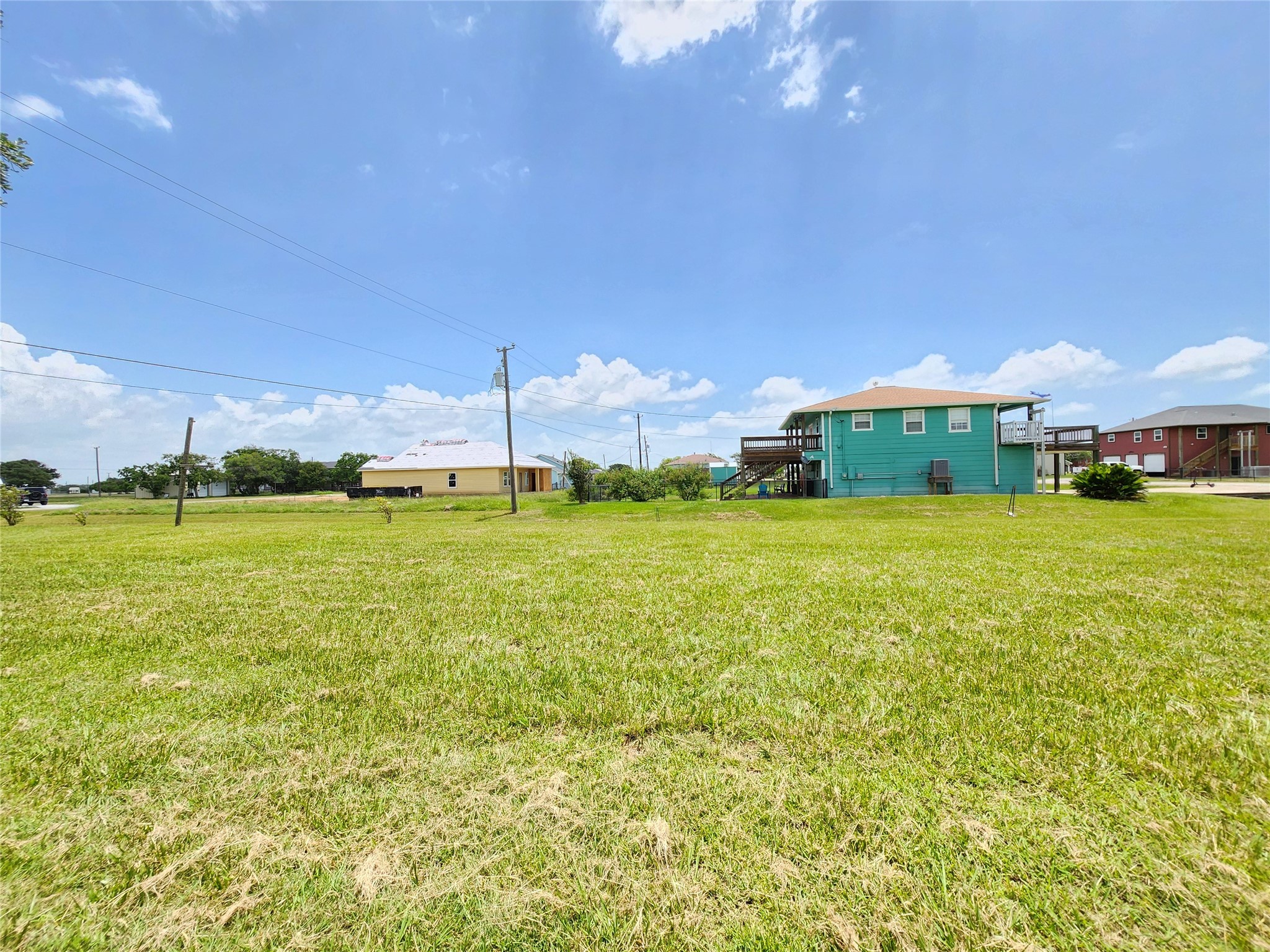 853 Swallow Drive Palacios, TX 77465 - Photo 13 of 20 a view of a big yard with plants and large trees