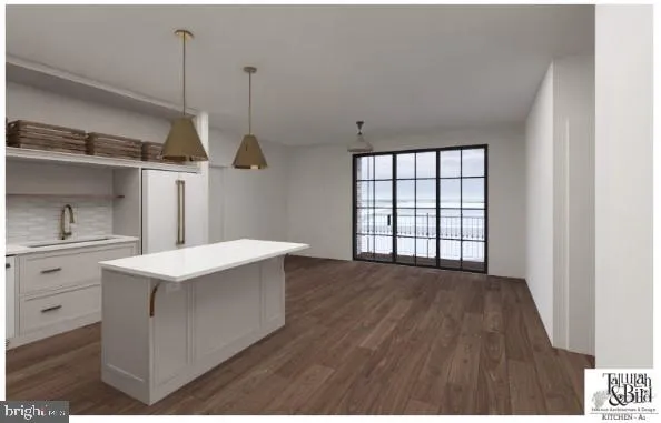 a kitchen with kitchen island a sink stove and wooden floor