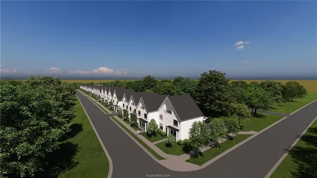 a large green field with lots of palm trees