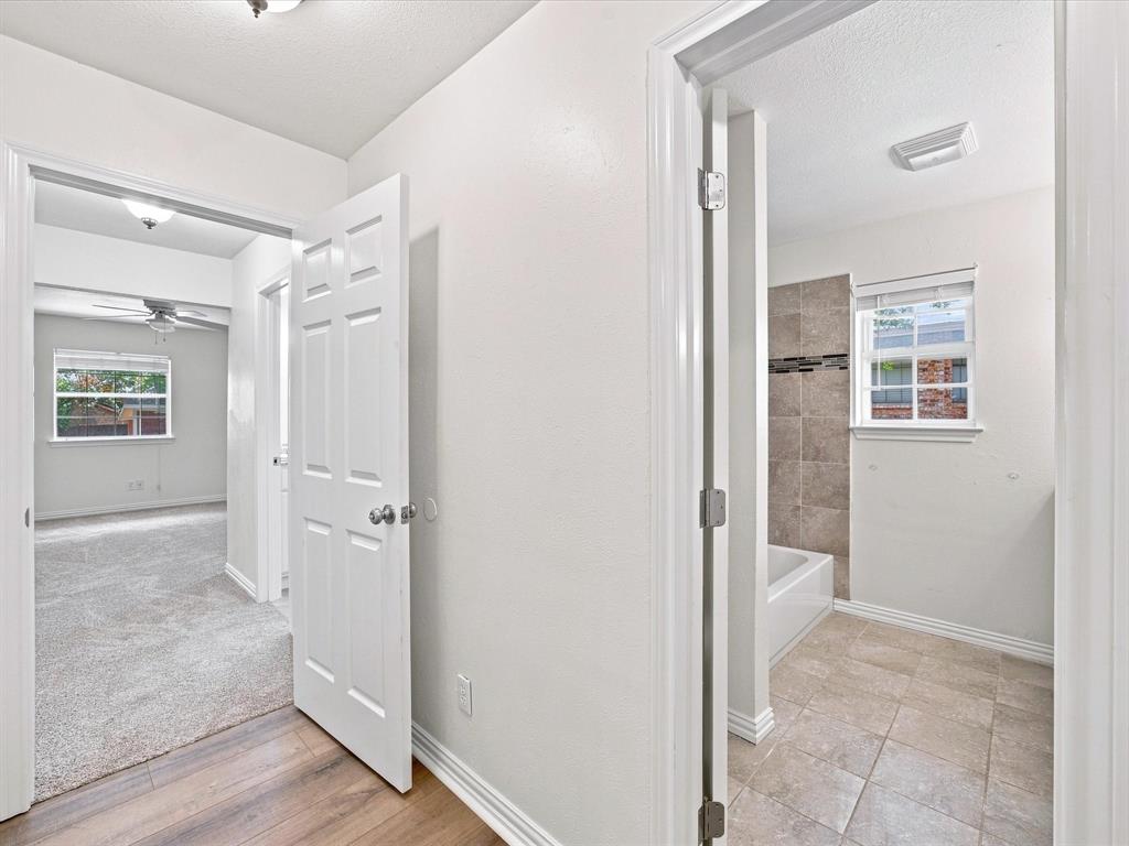 3107 South Lipsey Street Decatur, TX 76234 - Photo 21 of 40 Hallway with view to primary bedroom and guest bathroom
