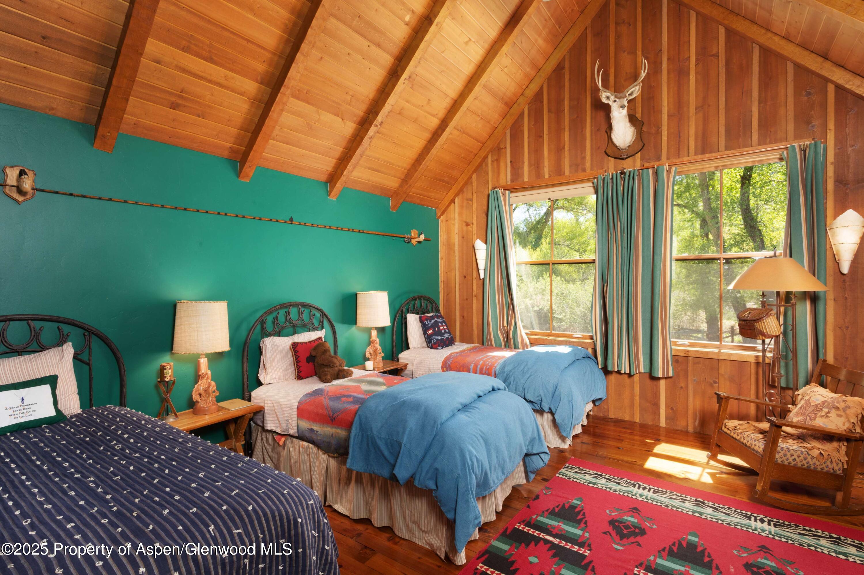 5548 Frying Pan Road Basalt, CO 81621 - Photo 18 of 53 a bedroom with two beds and next to a window