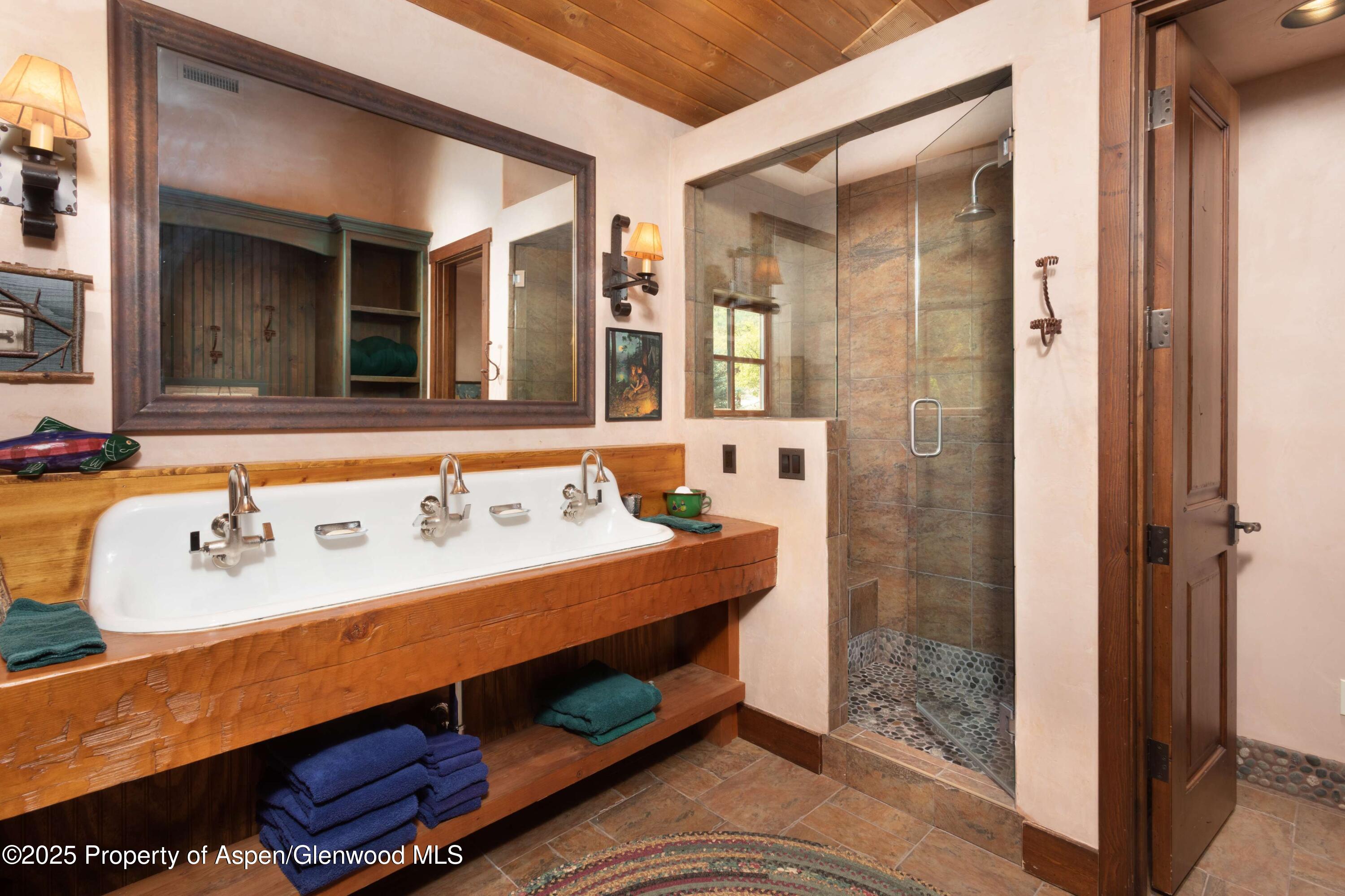 5548 Frying Pan Road Basalt, CO 81621 - Photo 19 of 53 a bathroom with a sink mirror and shower