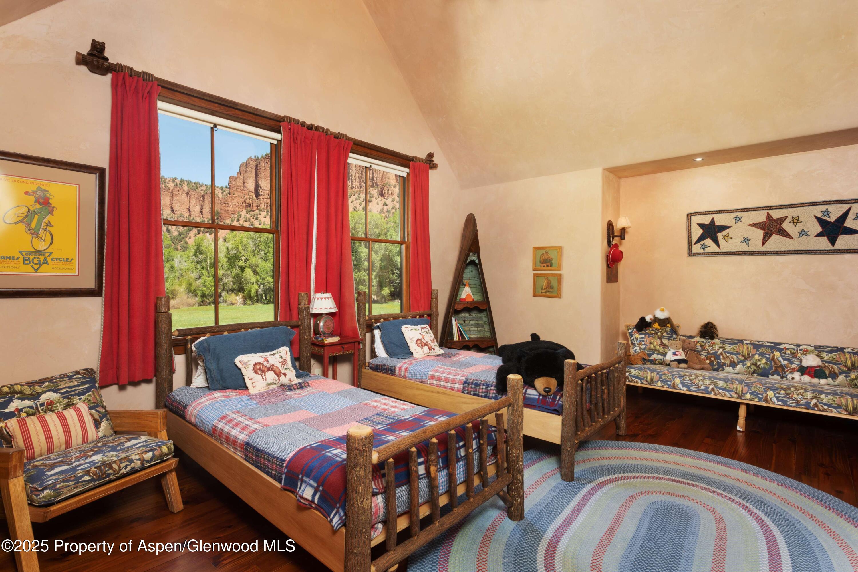 5548 Frying Pan Road Basalt, CO 81621 - Photo 20 of 53 a bedroom with a bed and wooden floor