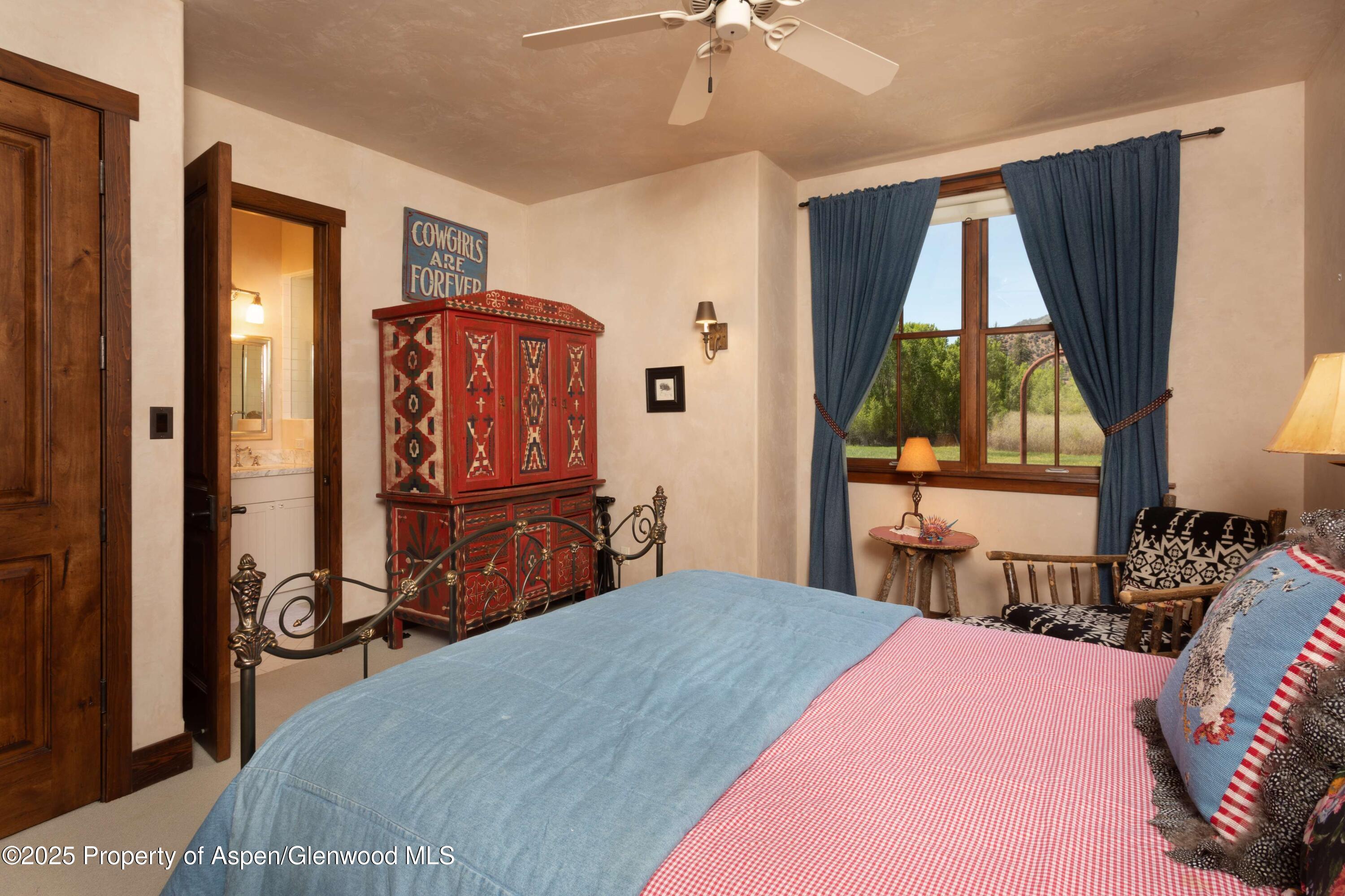5548 Frying Pan Road Basalt, CO 81621 - Photo 22 of 53 a bedroom with a bed and wooden floor