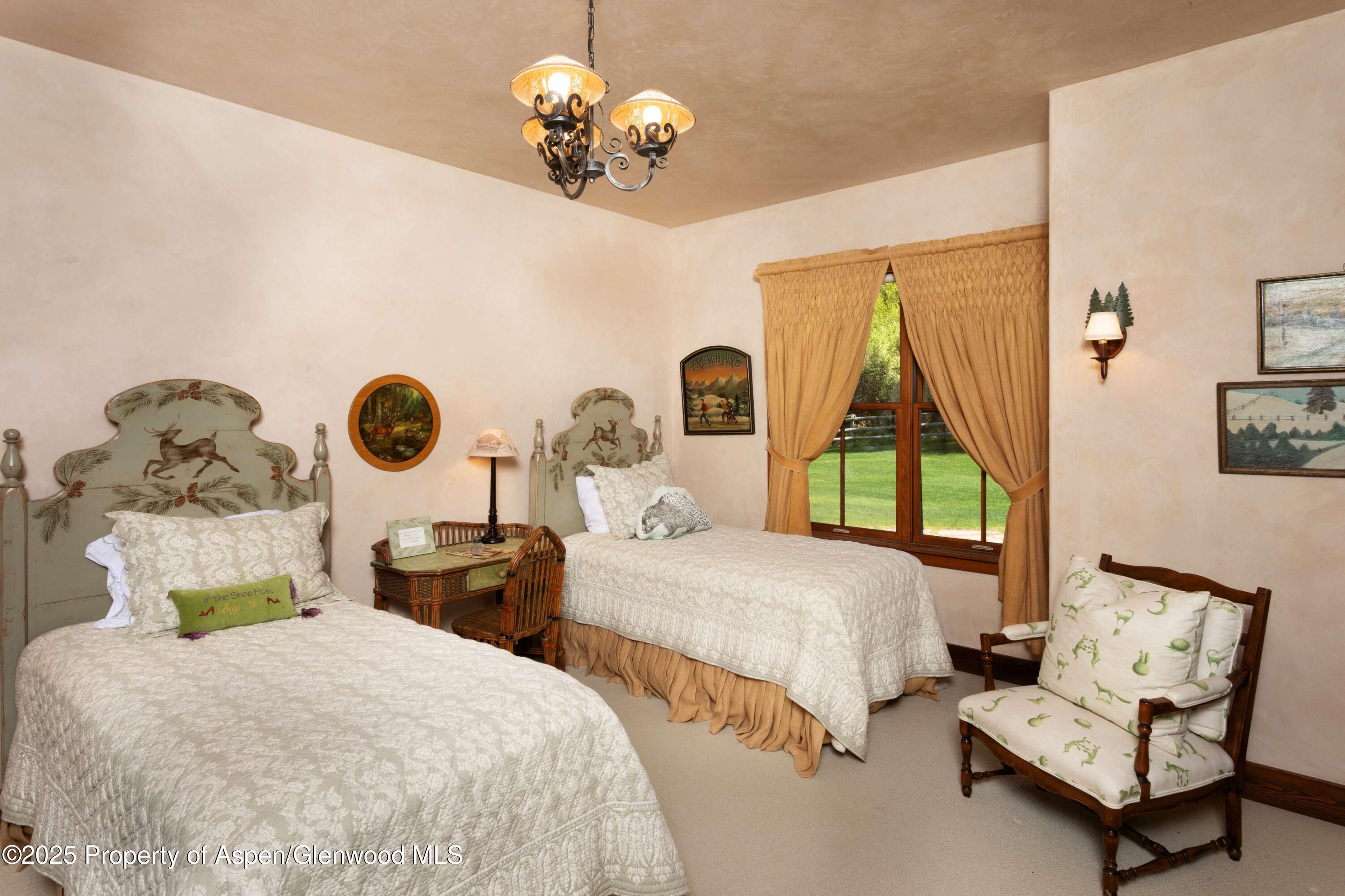 5548 Frying Pan Road Basalt, CO 81621 - Photo 24 of 53 a bedroom with two beds and paintings on the wall