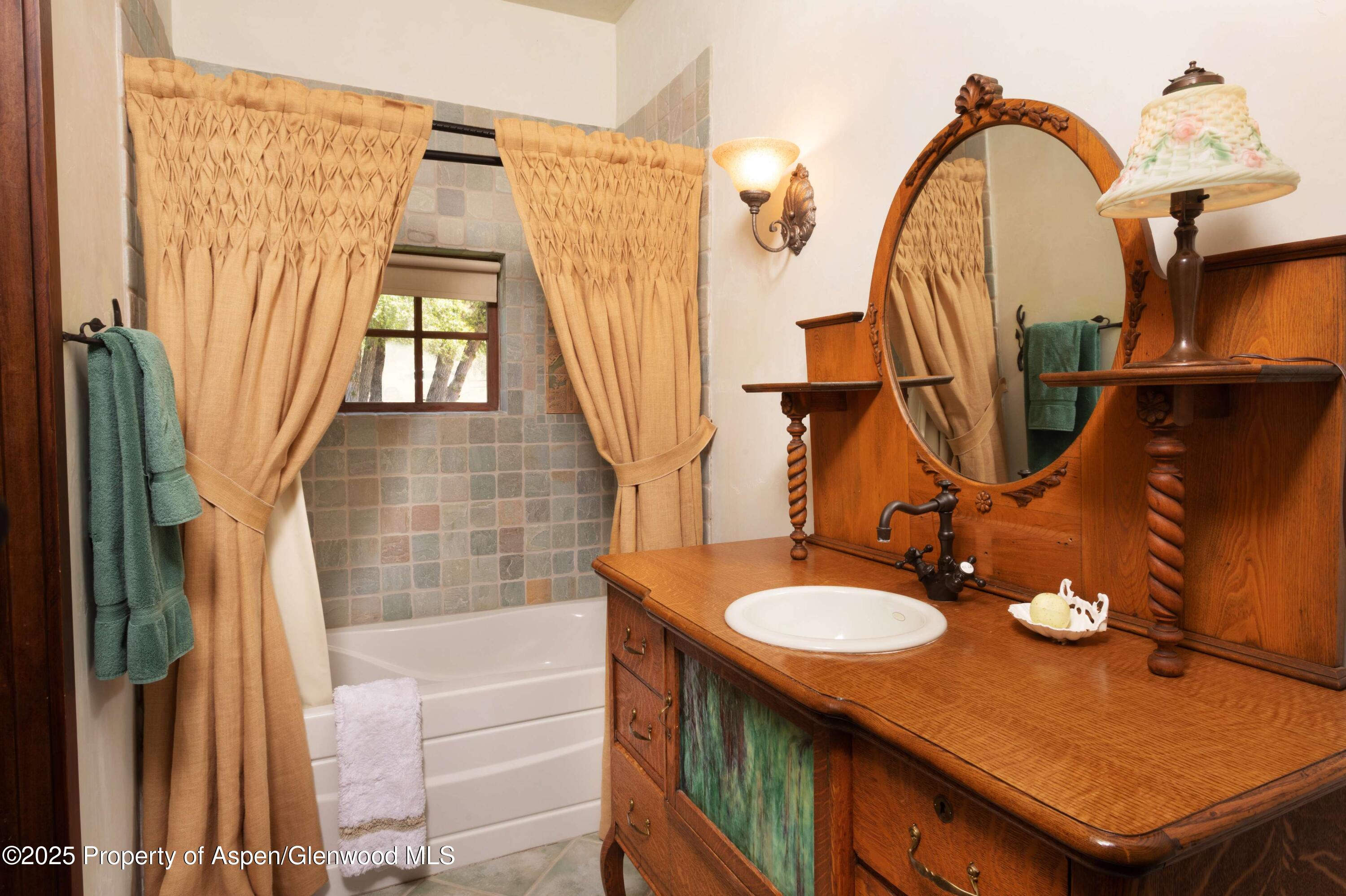 5548 Frying Pan Road Basalt, CO 81621 - Photo 25 of 53 a bathroom with a sink mirror and vanity