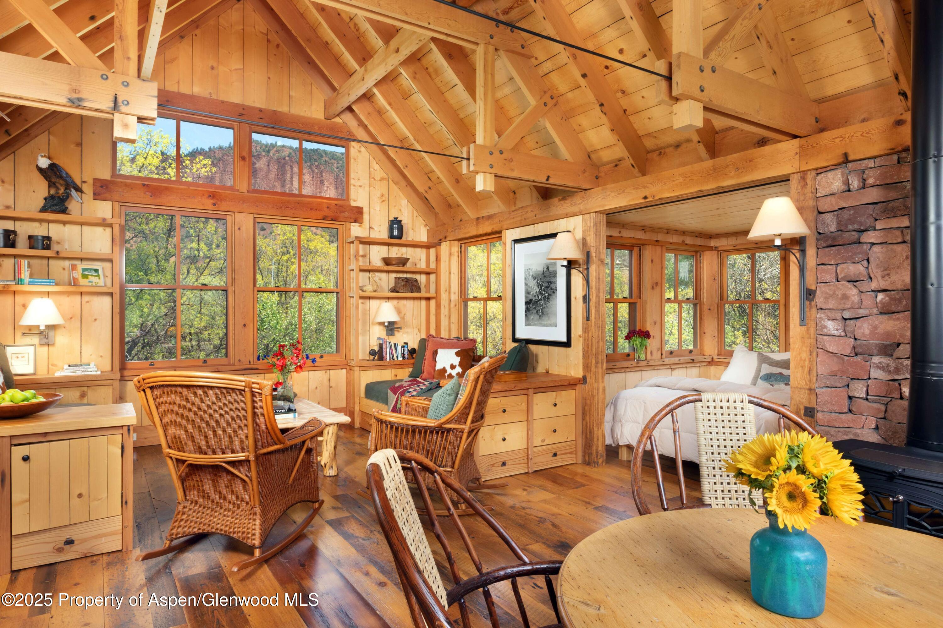 5548 Frying Pan Road Basalt, CO 81621 - Photo 31 of 53 a view of a dining room with furniture a chandelier and wooden floor