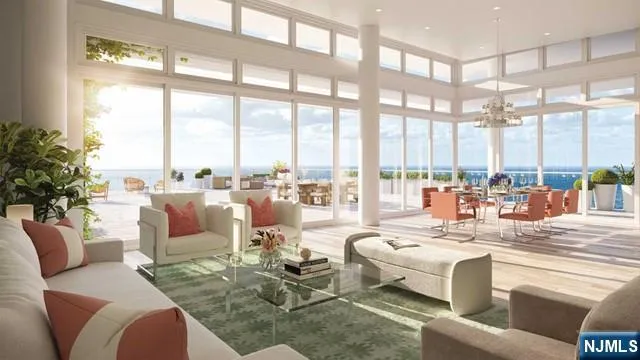 a living room with furniture large windows and a view of dining table