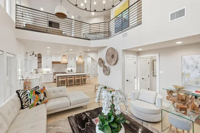 a dining room filled chandelier and wooden floor