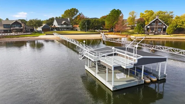 a view of swimming pool with outdoor seating and lake view