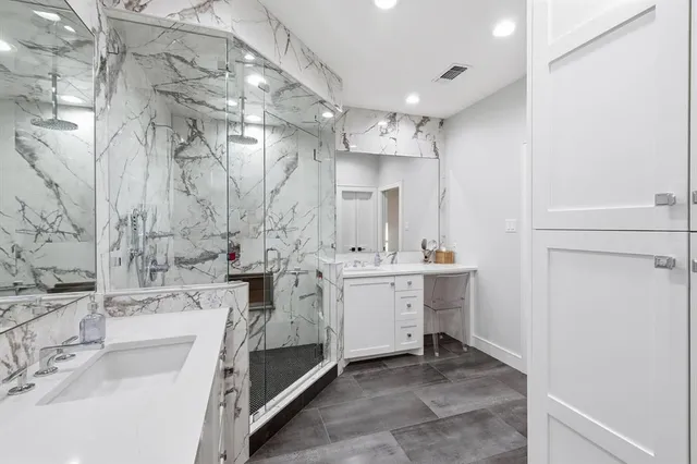 a bedroom with a large bed ceiling fan and a window