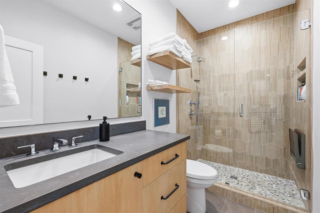 2285 Sage Circle Graford, TX 76449 - Photo 29 of 40 a bathroom with a sink a toilet a mirror and shower