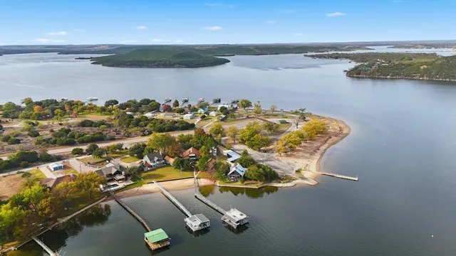 an aerial view of a house with a lake view